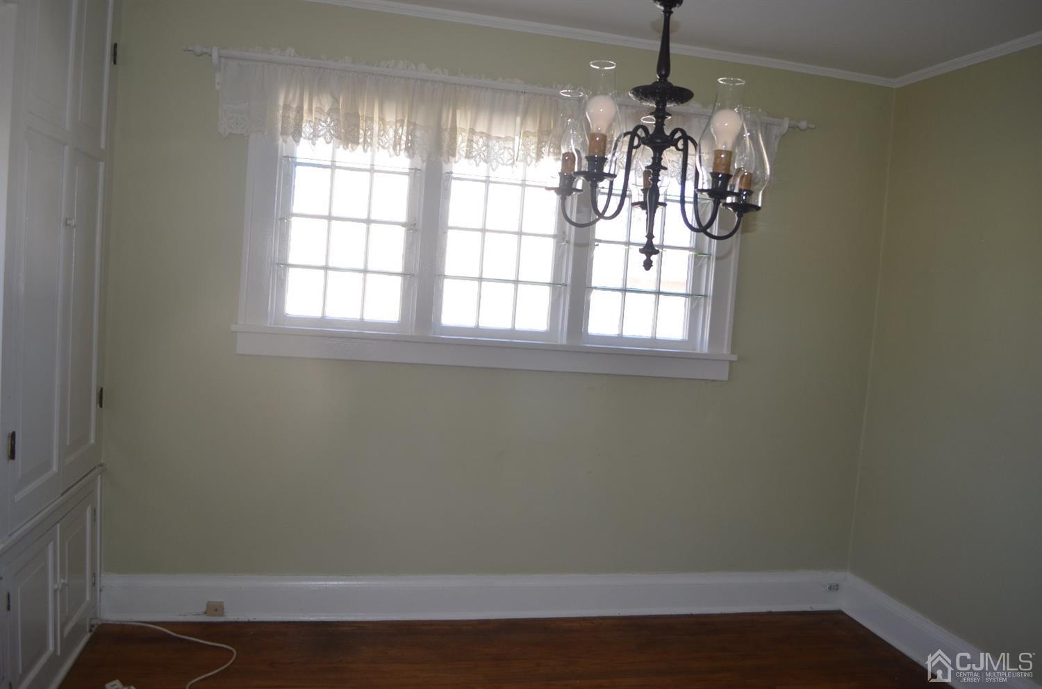 75 West Hill Road Colonia, NJ 07067 - Photo 15 of 35 an empty room with wooden floor and windows
