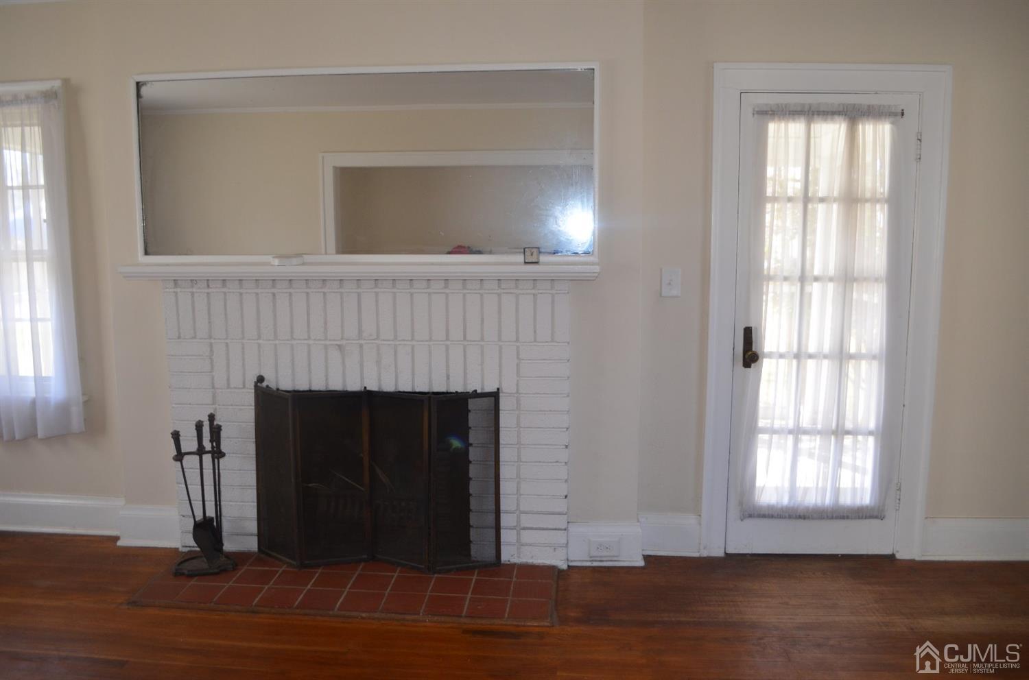 75 West Hill Road Colonia, NJ 07067 - Photo 16 of 35 a view of a livingroom with a fireplace and window