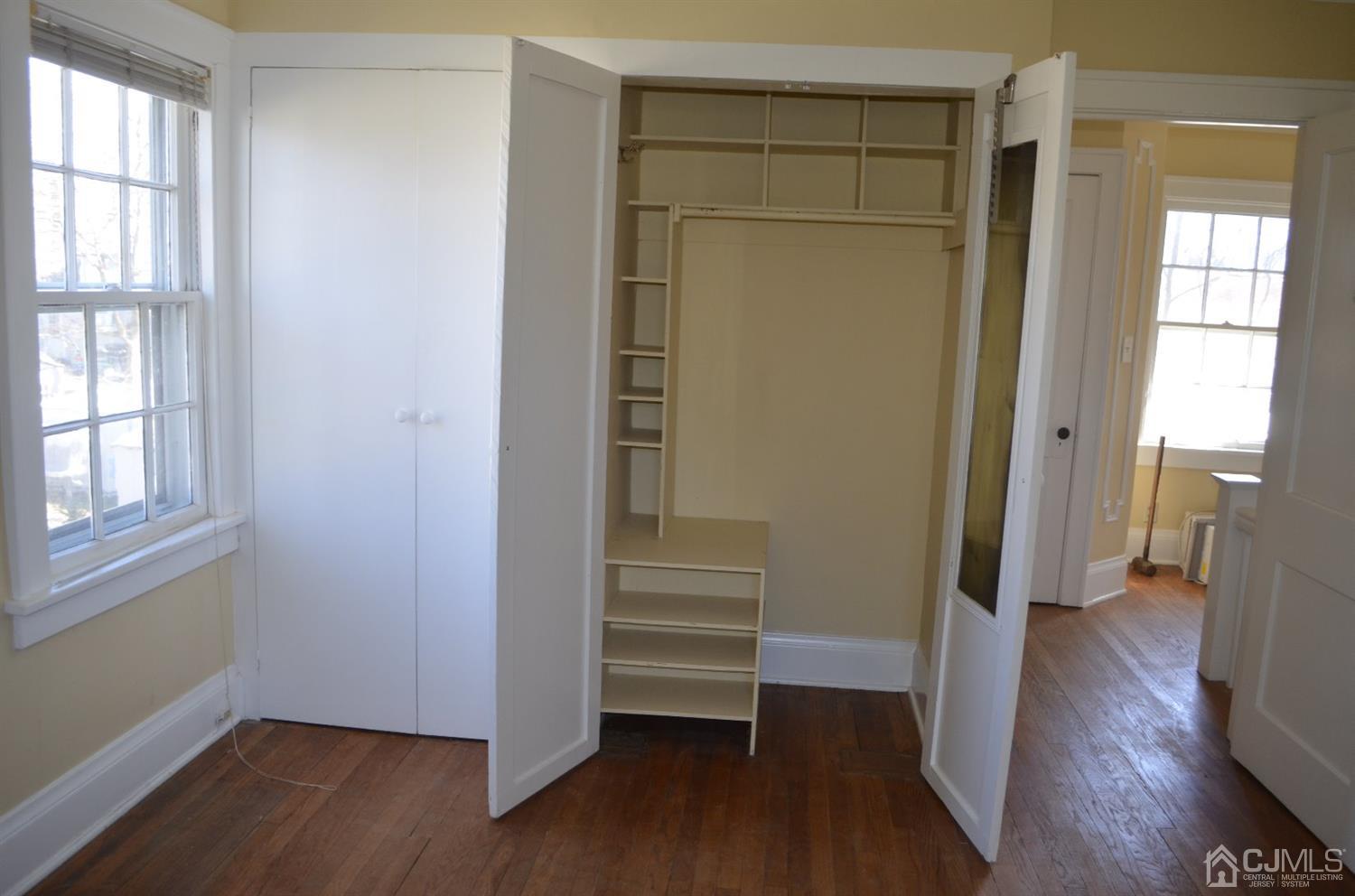 75 West Hill Road Colonia, NJ 07067 - Photo 20 of 35 an empty room with wooden floor closet and windows