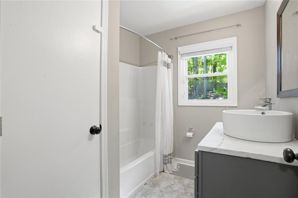 1430 Thomas Road Decatur, GA 30030 - Photo 29 of 42 a bathroom with a sink a toilet and shower