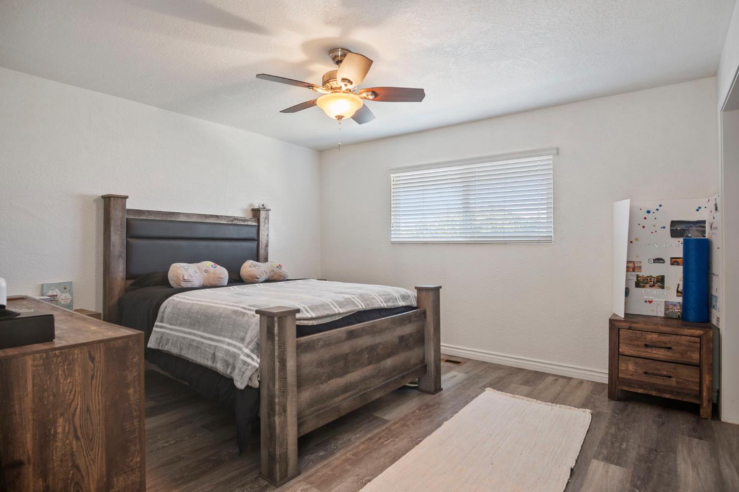 20201 Dustin Road Acampo, CA 95220 - Photo 11 of 23 a bed room with a bed and a chandelier