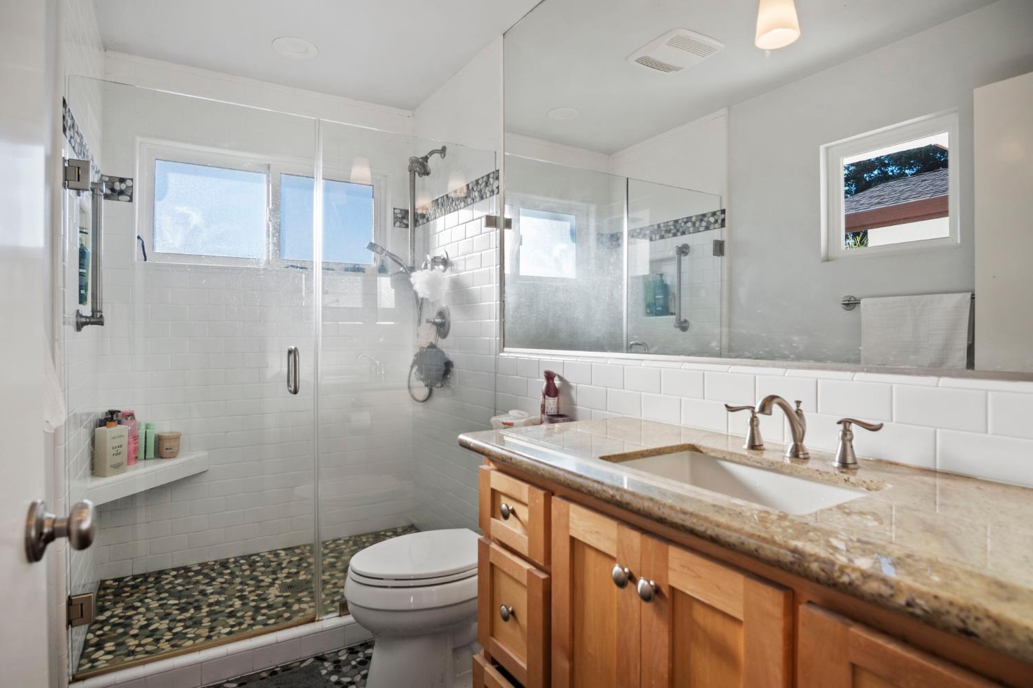 20201 Dustin Road Acampo, CA 95220 - Photo 13 of 23 a bathroom with a granite countertop toilet sink and a mirror