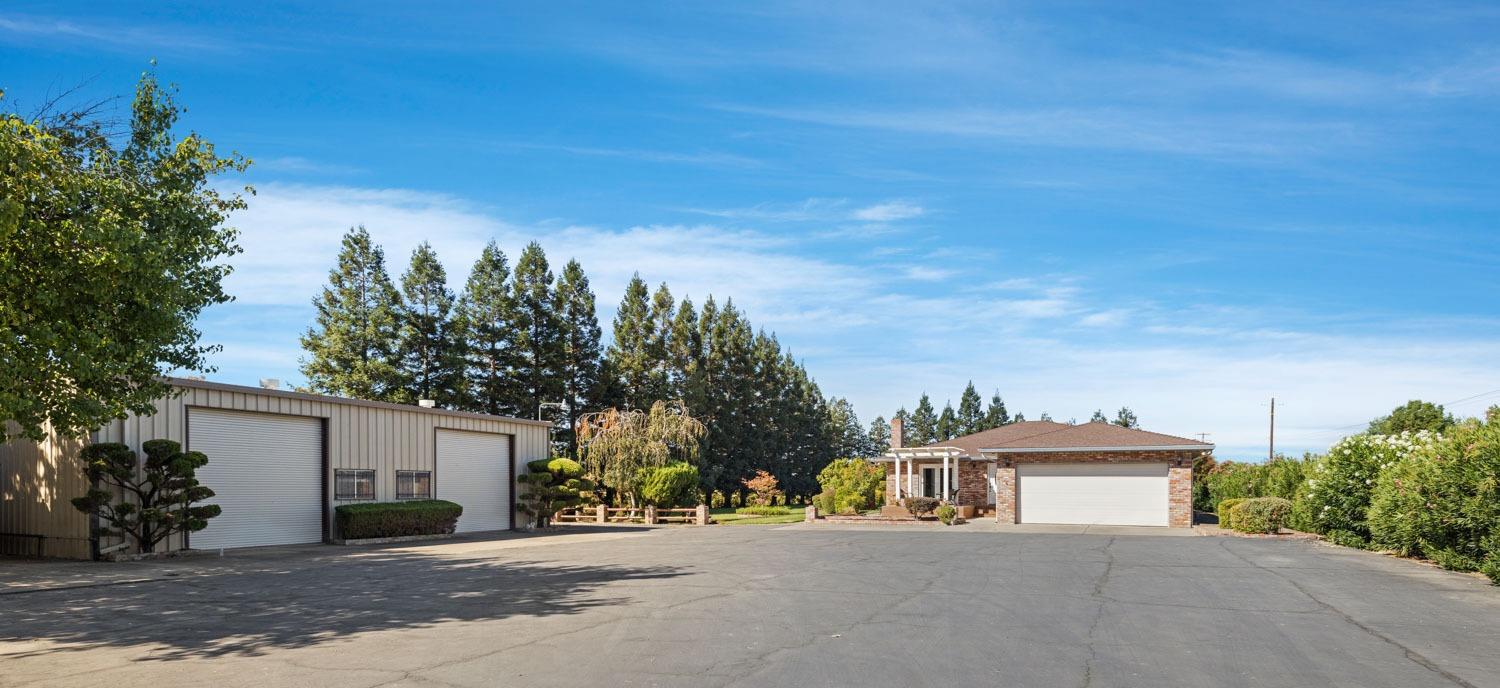 20201 Dustin Road Acampo, CA 95220 - Photo 15 of 23 a front view of a house with a yard and garage