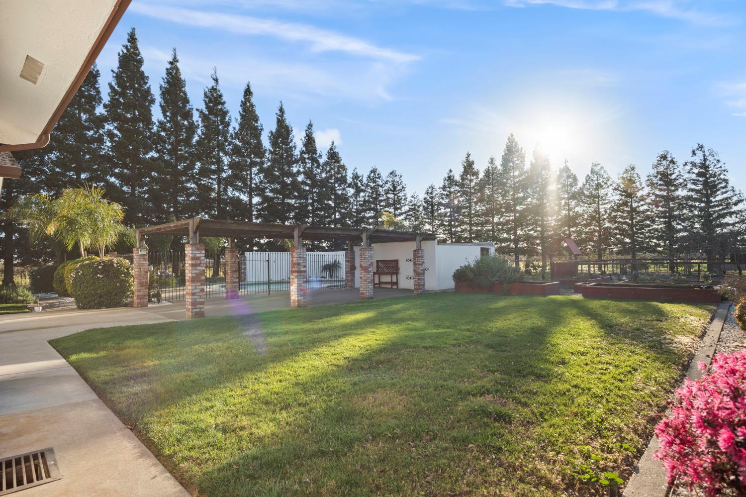 20201 Dustin Road Acampo, CA 95220 - Photo 21 of 23 a view of a house with swimming pool next to a yard