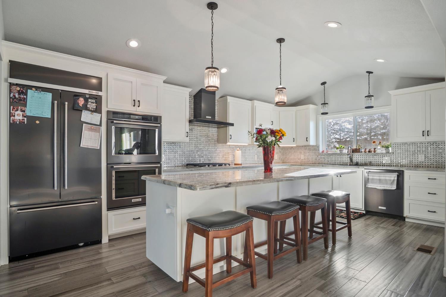 20201 Dustin Road Acampo, CA 95220 - Photo 8 of 23 a kitchen with stainless steel appliances granite countertop a wooden floor and white cabinets