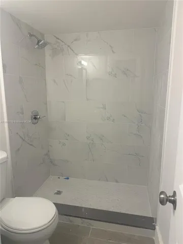 a bathroom with a toilet and shower