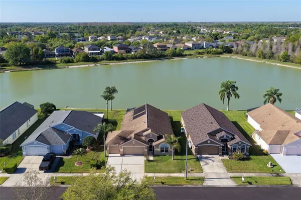 an aerial view of a house with a lake view