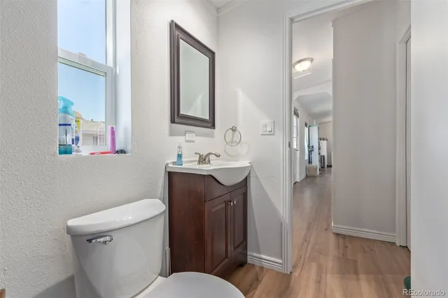 a bathroom with a sink a toilet a mirror and vanity