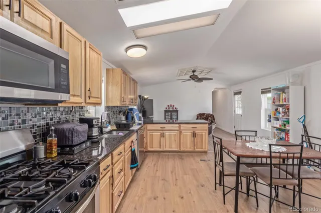 a kitchen with a stove a sink and cabinets