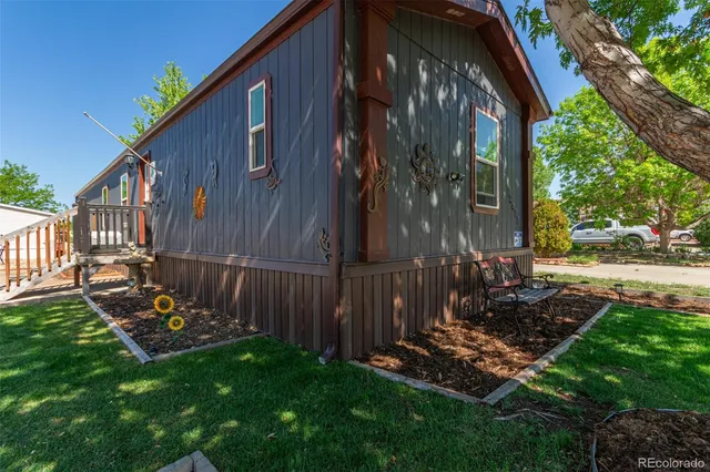 a view of a house with backyard and sitting area