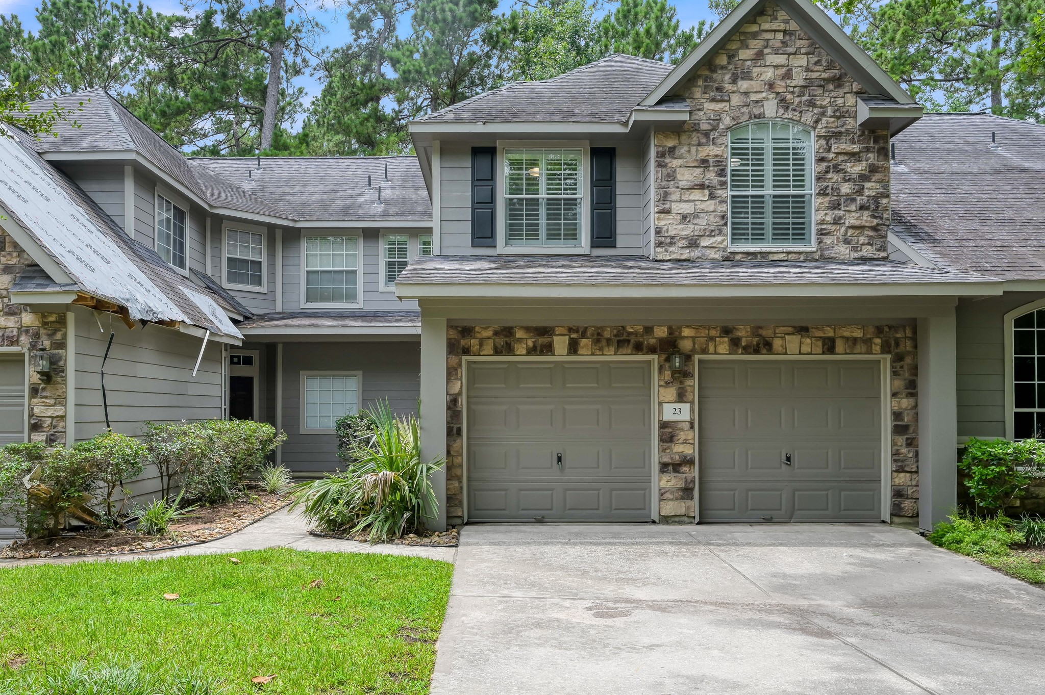 23 Alderon Woods Place Spring, TX 77382 - Photo 6 of 25 a front view of a house with a yard and garage