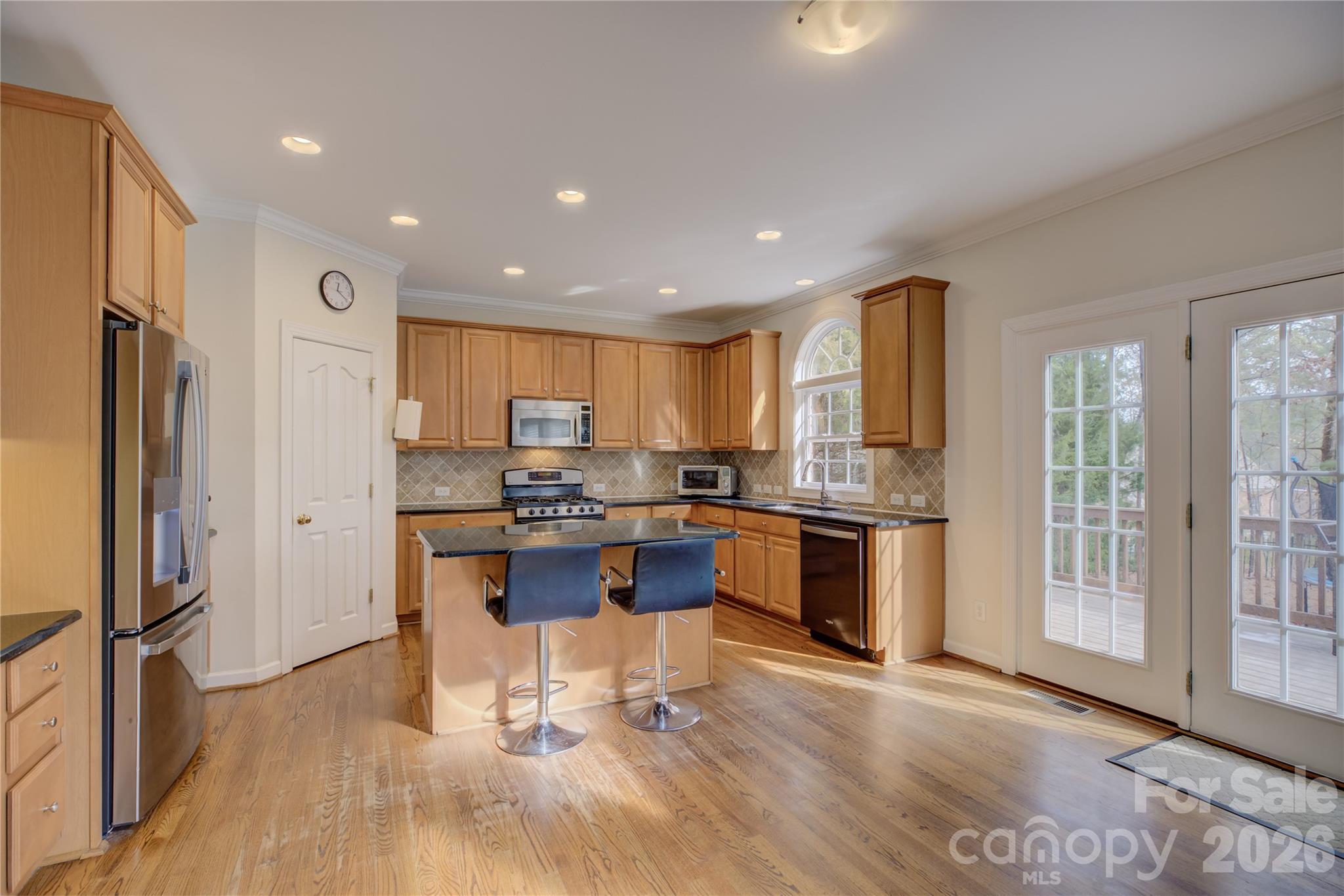 16624 Turtle Point Road Charlotte, NC 28278 - Photo 12 of 46 a kitchen with stainless steel appliances granite countertop a refrigerator oven a sink dishwasher and white cabinets with wooden floor