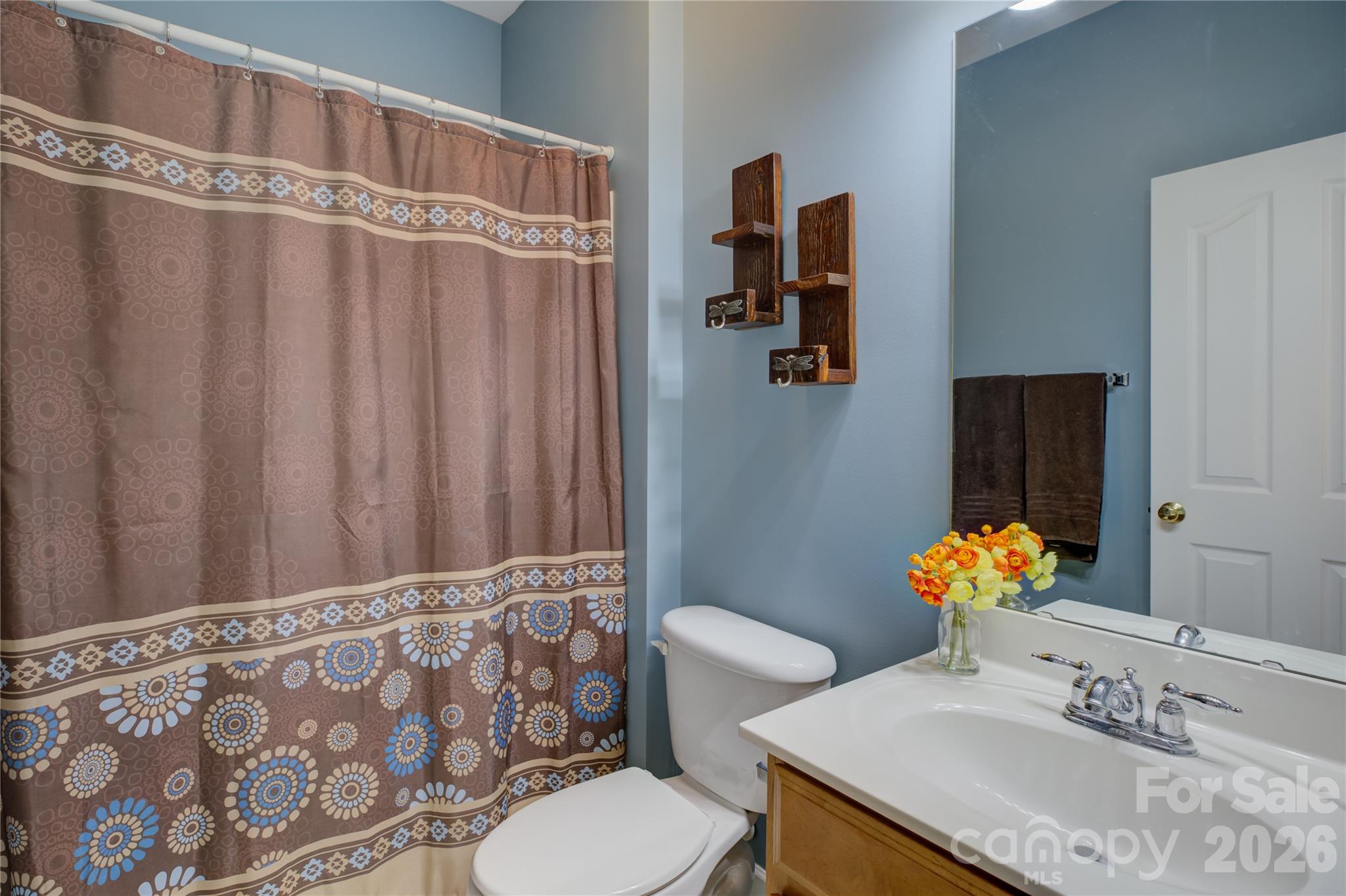 16624 Turtle Point Road Charlotte, NC 28278 - Photo 22 of 46 a bathroom with a sink toilet and mirror
