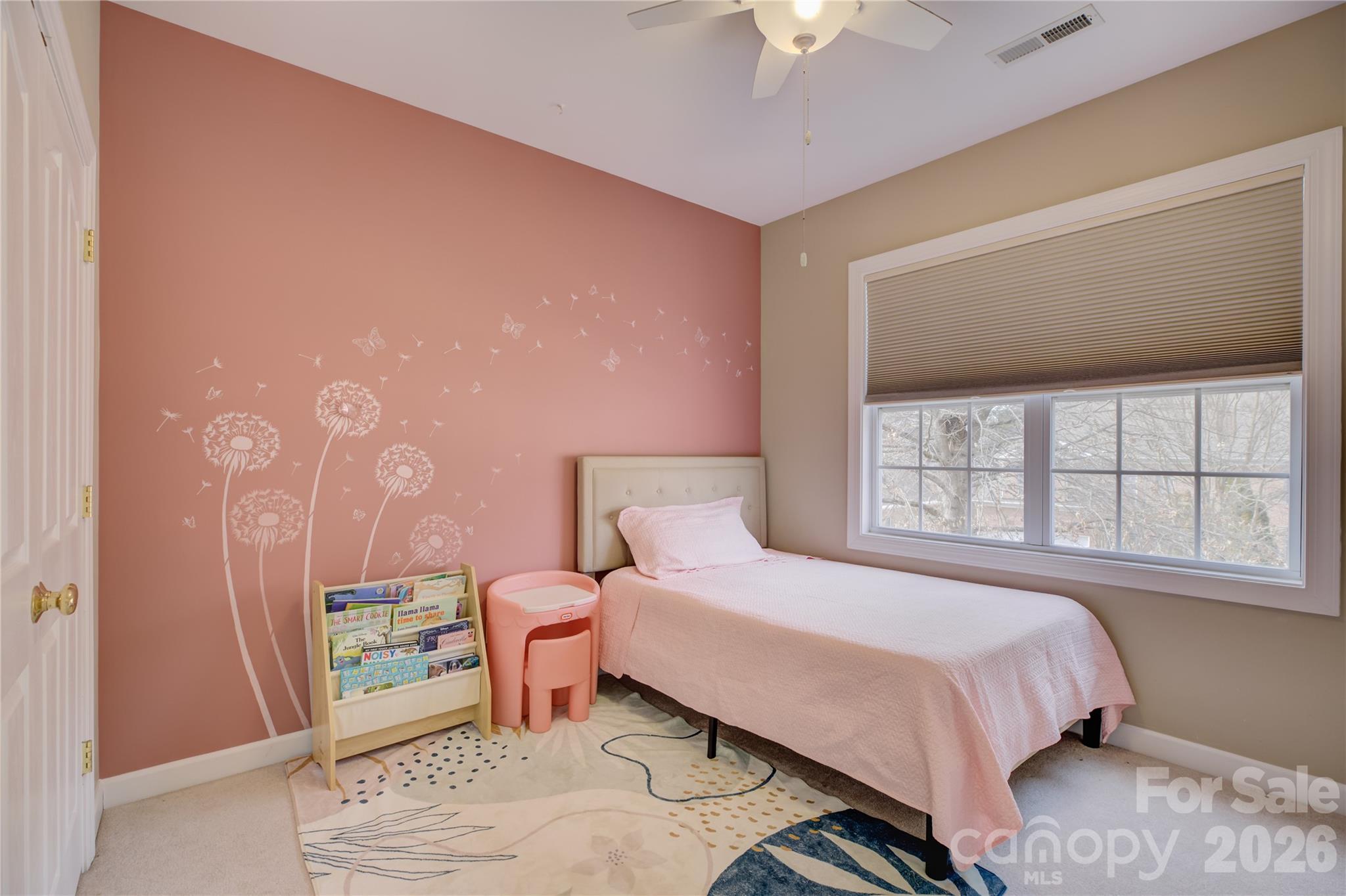 16624 Turtle Point Road Charlotte, NC 28278 - Photo 33 of 46 a bedroom with a bed and a chandelier