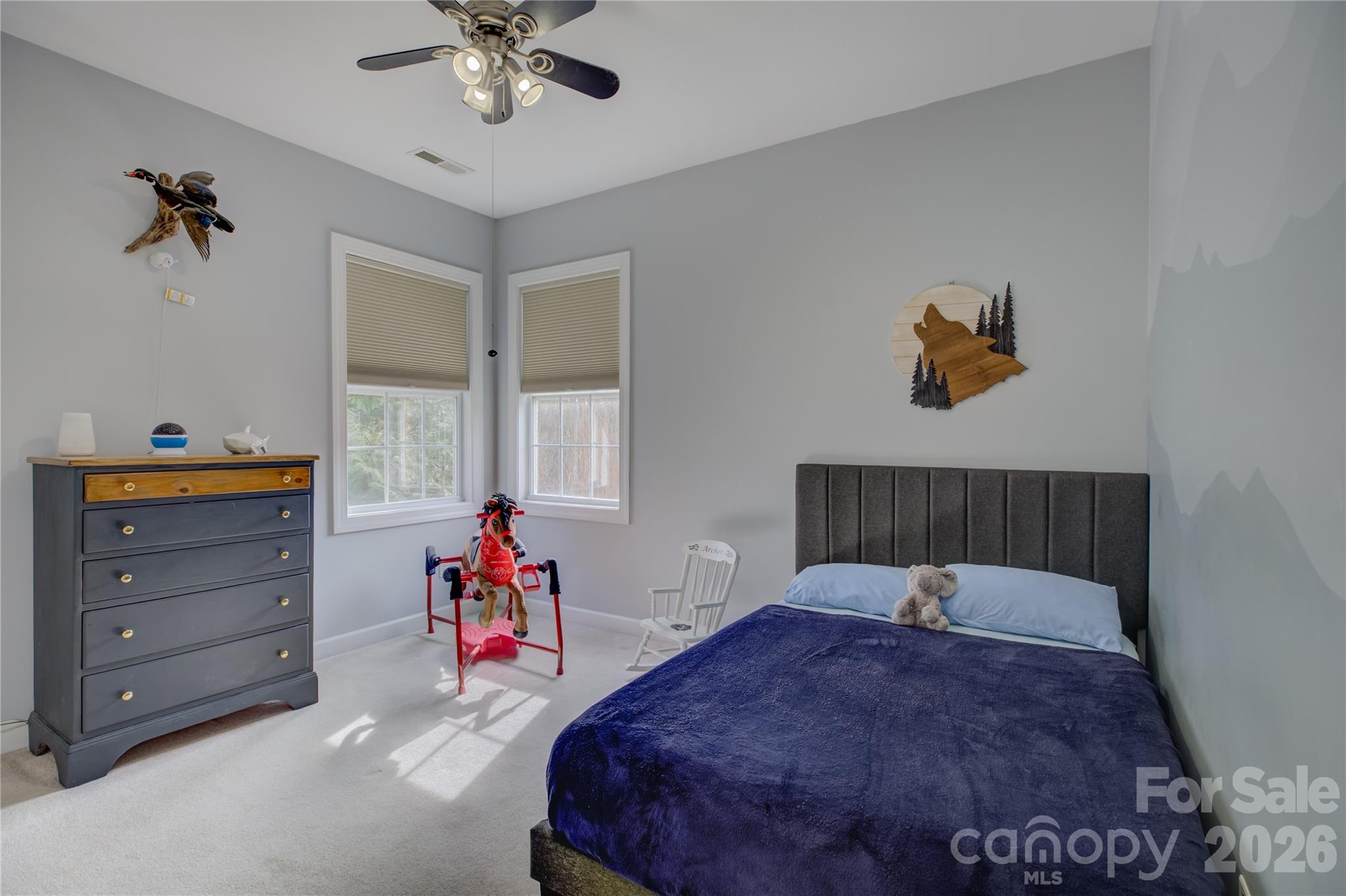 16624 Turtle Point Road Charlotte, NC 28278 - Photo 36 of 46 a bed room with a bed and a chandelier