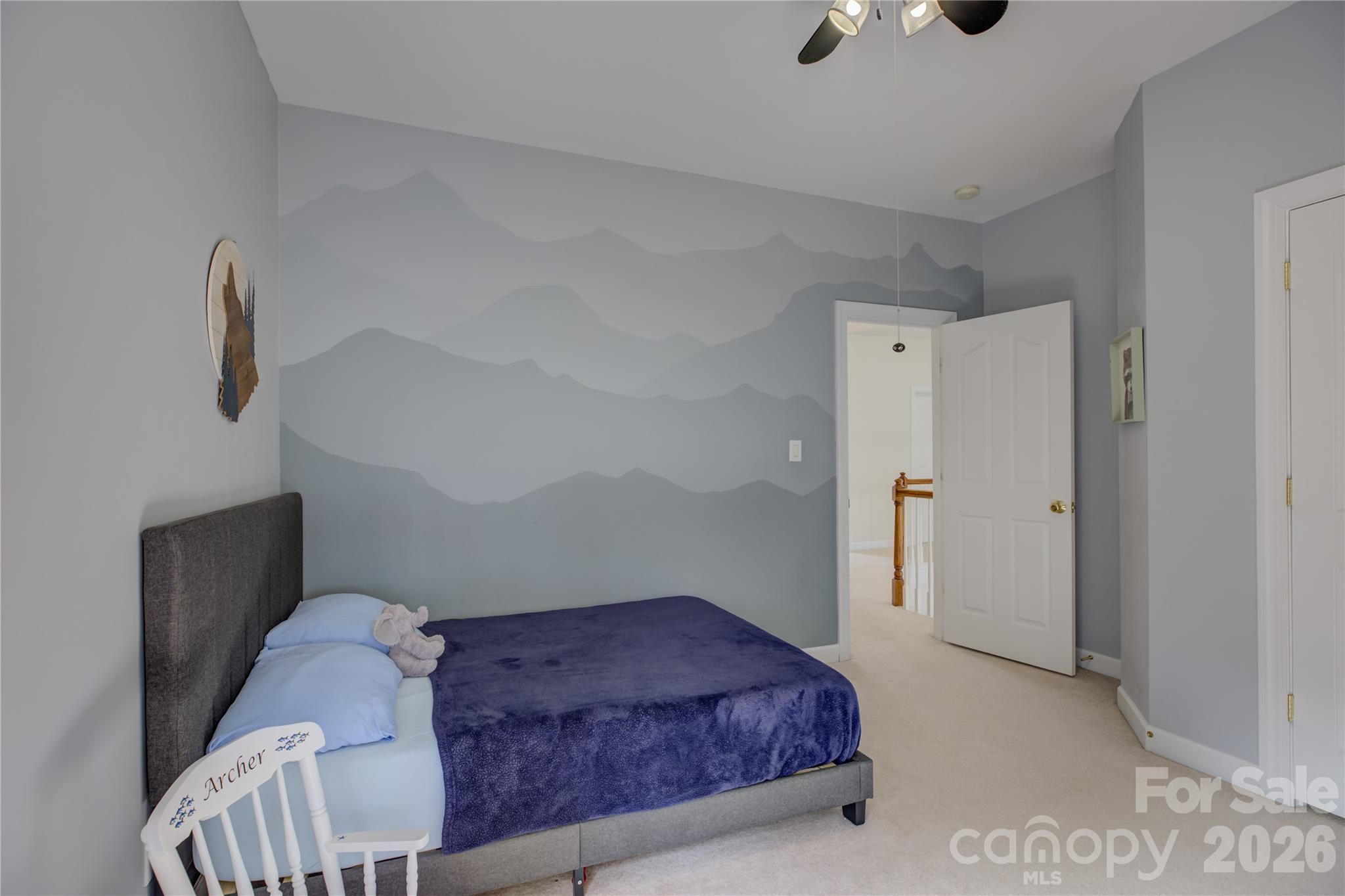 16624 Turtle Point Road Charlotte, NC 28278 - Photo 37 of 46 a bedroom with a bed and a chandelier