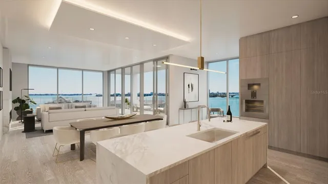 a kitchen with a sink and chairs