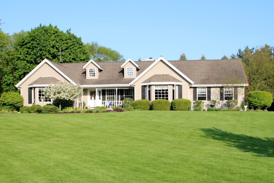 11627 Prestwick Road Belvidere, IL 61008 - Photo 1 of 25 a front view of a house with a garden