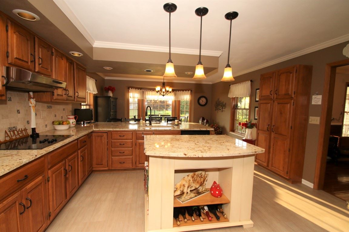 11627 Prestwick Road Belvidere, IL 61008 - Photo 11 of 25 a kitchen with stainless steel appliances granite countertop a sink a stove and a wooden floors