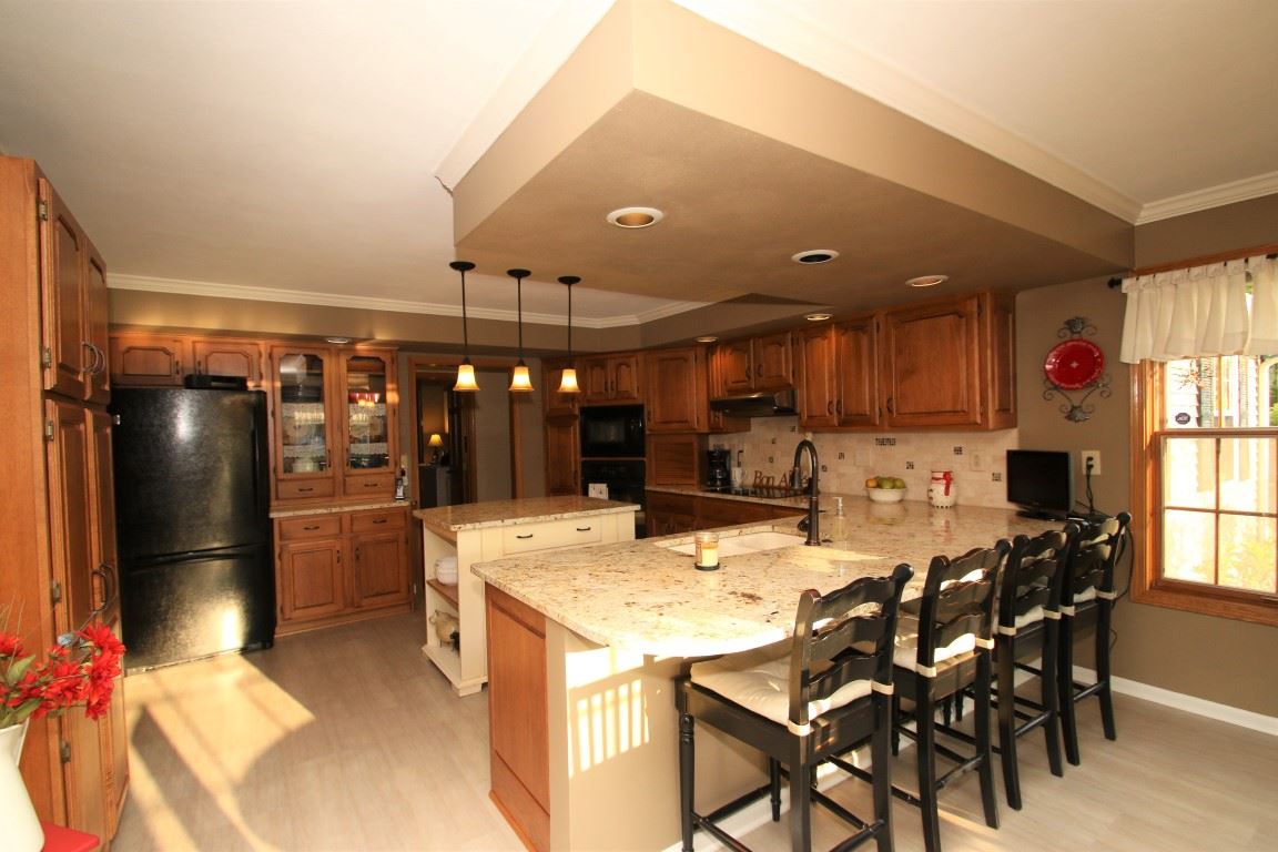 11627 Prestwick Road Belvidere, IL 61008 - Photo 13 of 25 a kitchen with a dining table cabinets and stainless steel appliances