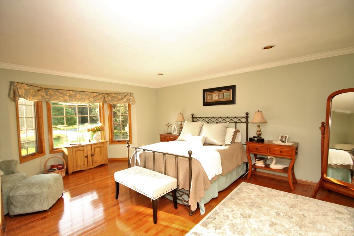 11627 Prestwick Road Belvidere, IL 61008 - Photo 14 of 25 a spacious bedroom with a bed and wooden floor