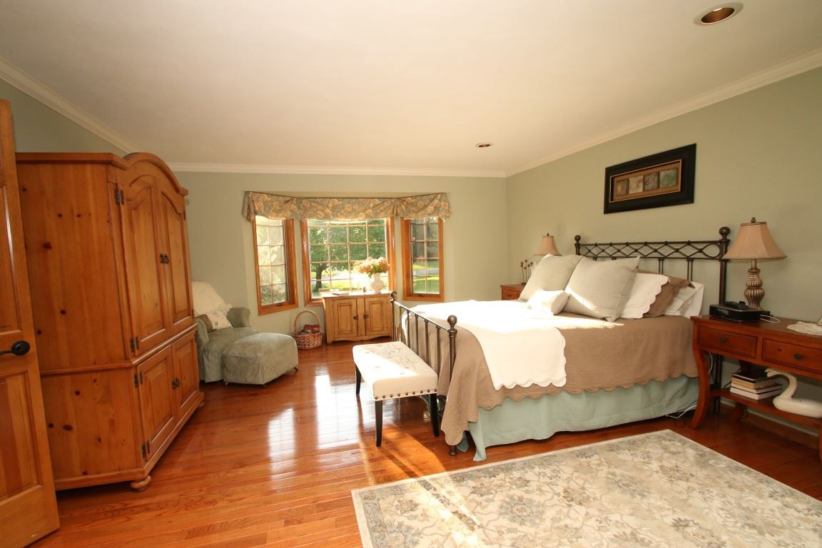 11627 Prestwick Road Belvidere, IL 61008 - Photo 15 of 25 a bedroom with a bed and wooden floor