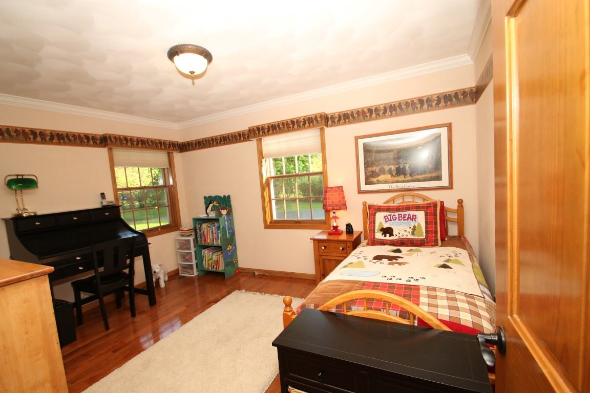 11627 Prestwick Road Belvidere, IL 61008 - Photo 17 of 25 a bedroom with a bed and wooden floor