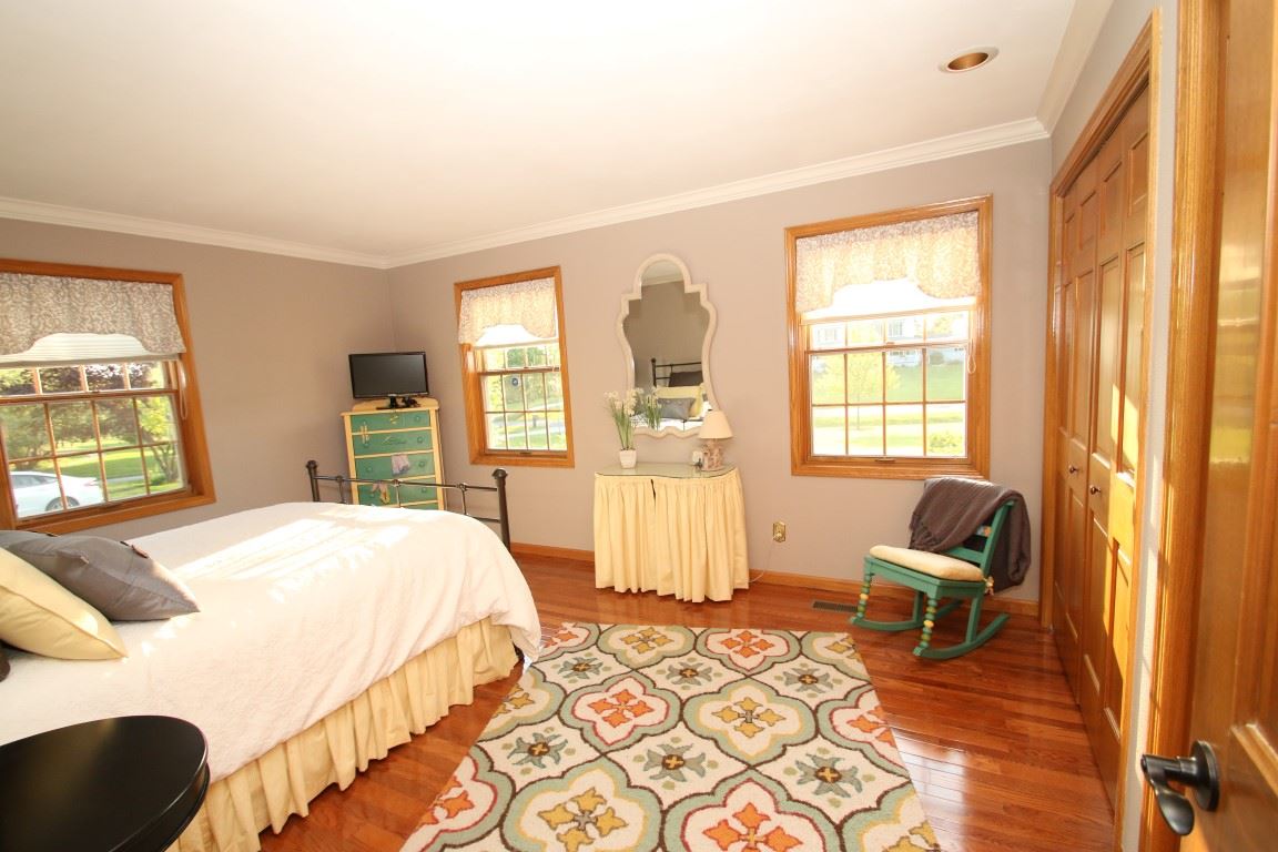 11627 Prestwick Road Belvidere, IL 61008 - Photo 18 of 25 a bedroom with a bed and wooden floor