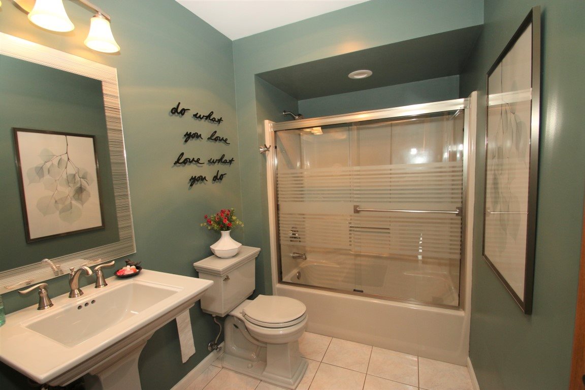 11627 Prestwick Road Belvidere, IL 61008 - Photo 20 of 25 a bathroom with a sink mirror toilet and shower