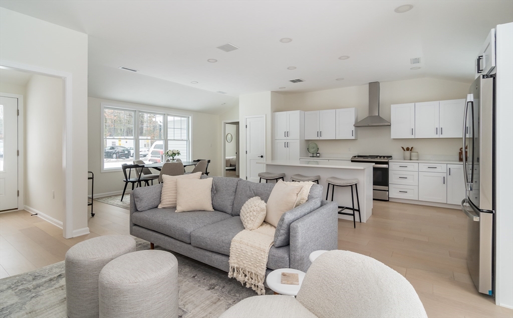 90 Oxbow Road Wayland, MA 01778 - Photo 10 of 17 a living room with furniture white walls and kitchen view