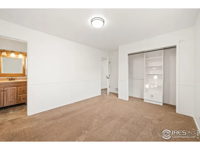 a bathroom with a sink a toilet a mirror and shower