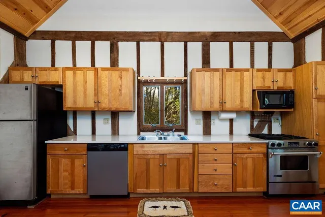 a kitchen with cabinets and a wooden floor