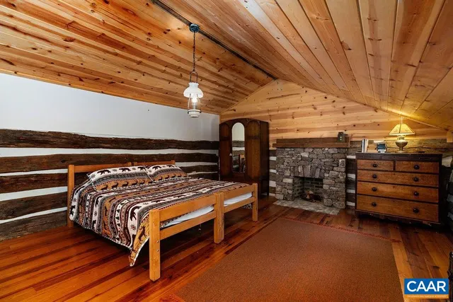 a room with fireplace furniture and a wooden floor