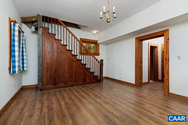 a living room with furniture ceiling fan and a wooden floor