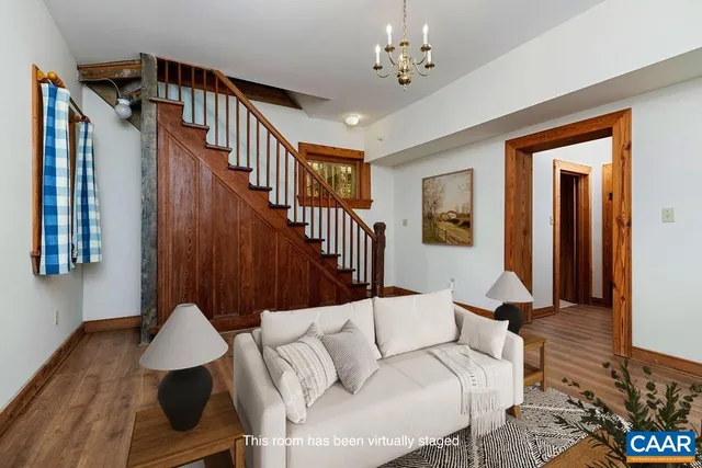 a side view of a water heater room with wooden floor