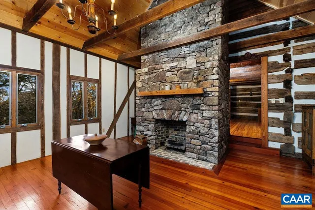 a living room with furniture a fireplace and wooden floor