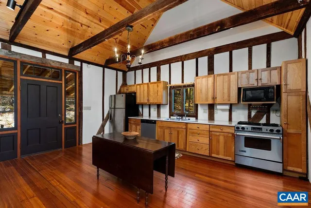 a kitchen with stainless steel appliances granite countertop a stove and a refrigerator