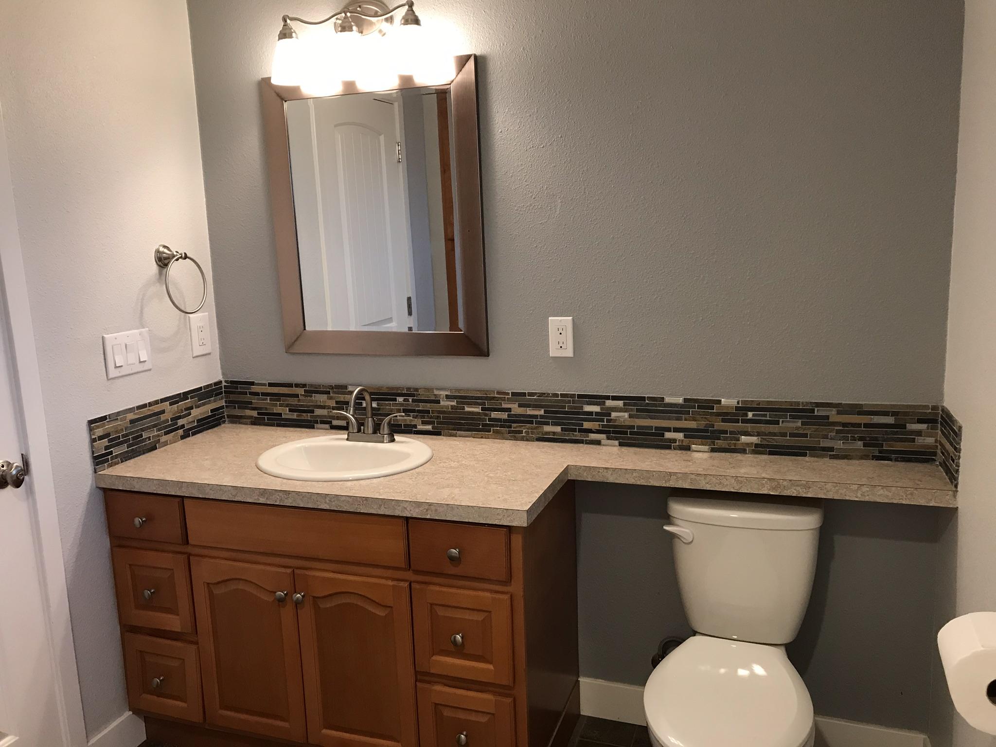 5601 Eastside Road Redding, CA 96001 - Photo 12 of 22 a bathroom with a toilet sink and mirror