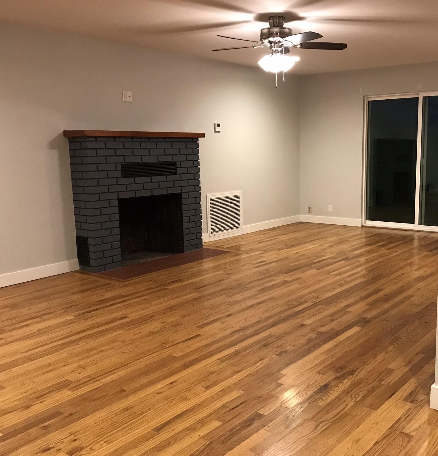 5601 Eastside Road Redding, CA 96001 - Photo 3 of 22 a view of an empty room with wooden floor and a fireplace