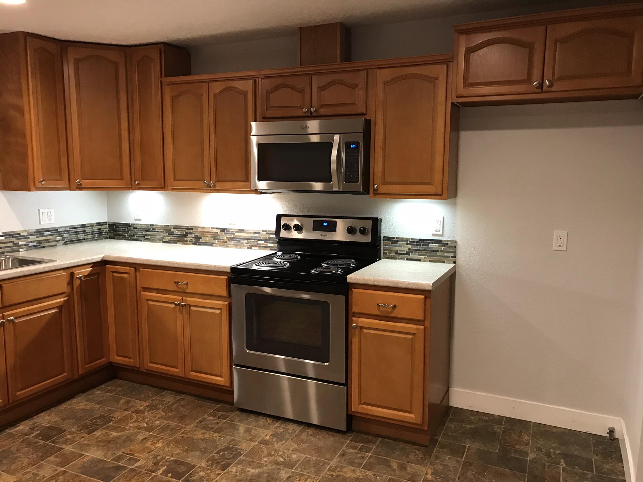 5601 Eastside Road Redding, CA 96001 - Photo 6 of 22 a kitchen with stainless steel appliances granite countertop a stove a microwave and a sink