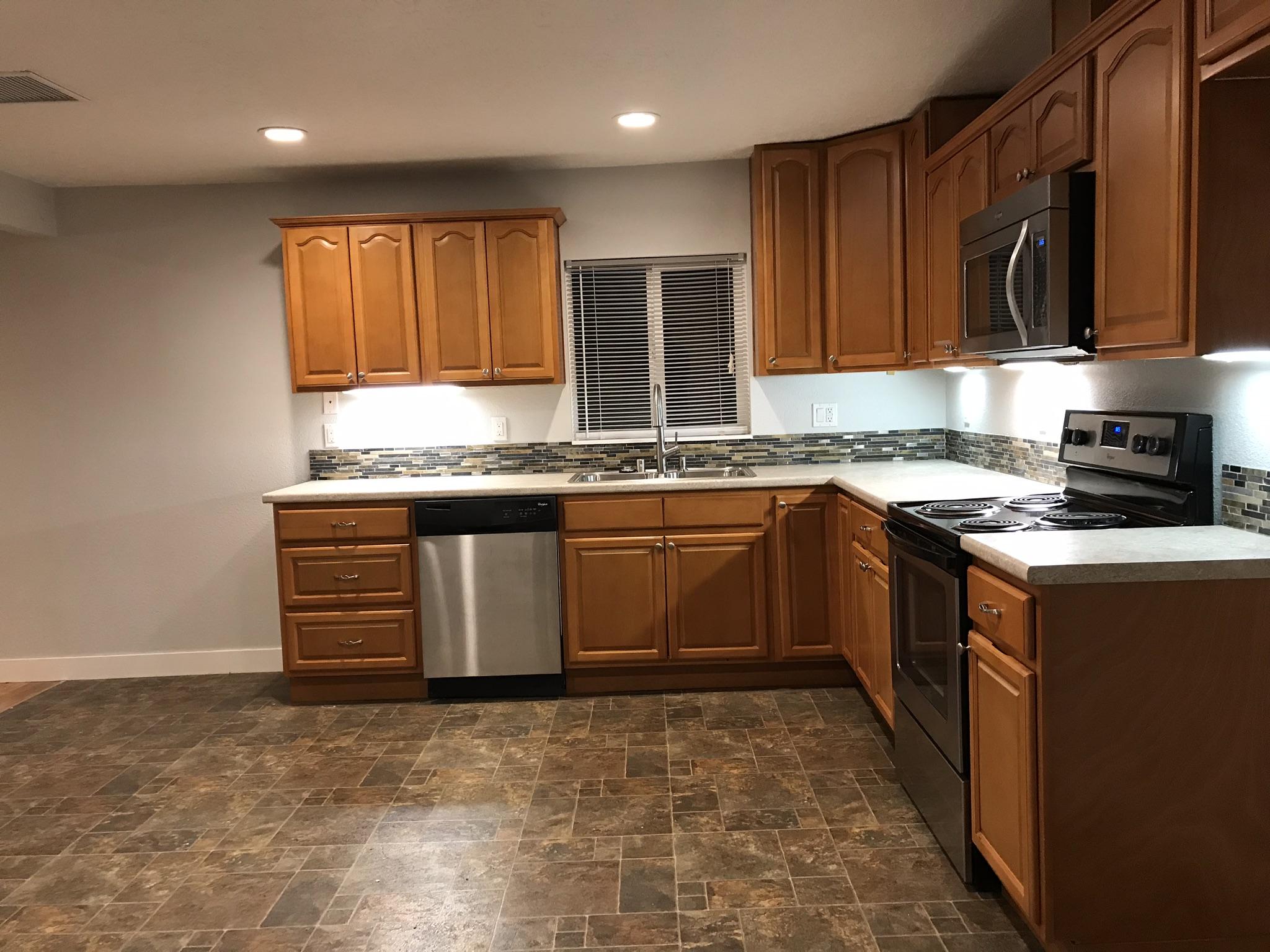 5601 Eastside Road Redding, CA 96001 - Photo 7 of 22 a kitchen with stainless steel appliances granite countertop a stove a sink and a microwave