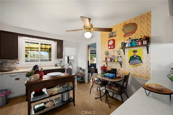 a kitchen with a refrigerator and a stove top open