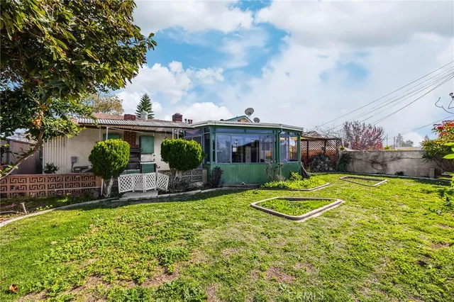 a view of a backyard with plants and a patio