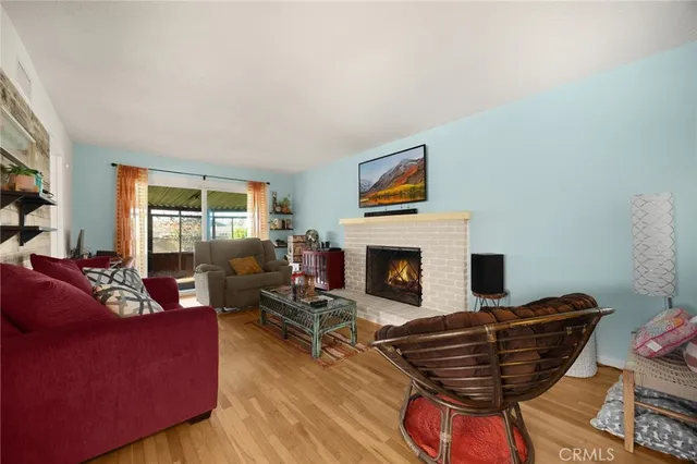 a living room with furniture a flat screen tv and a fireplace
