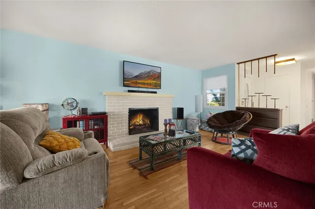 a living room with furniture a fireplace and a flat screen tv