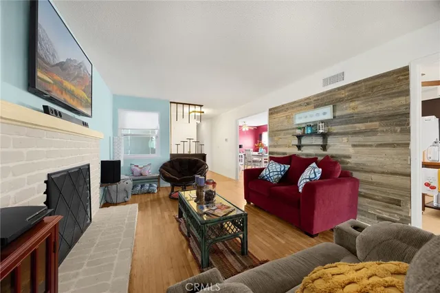 a living room with furniture a fireplace and a floor to ceiling window