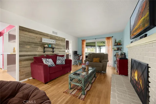 a view of a dining room with furniture a chandelier and wooden floor