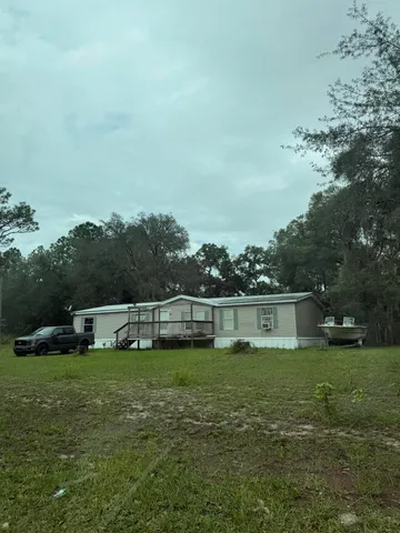 a view of lake with green yard