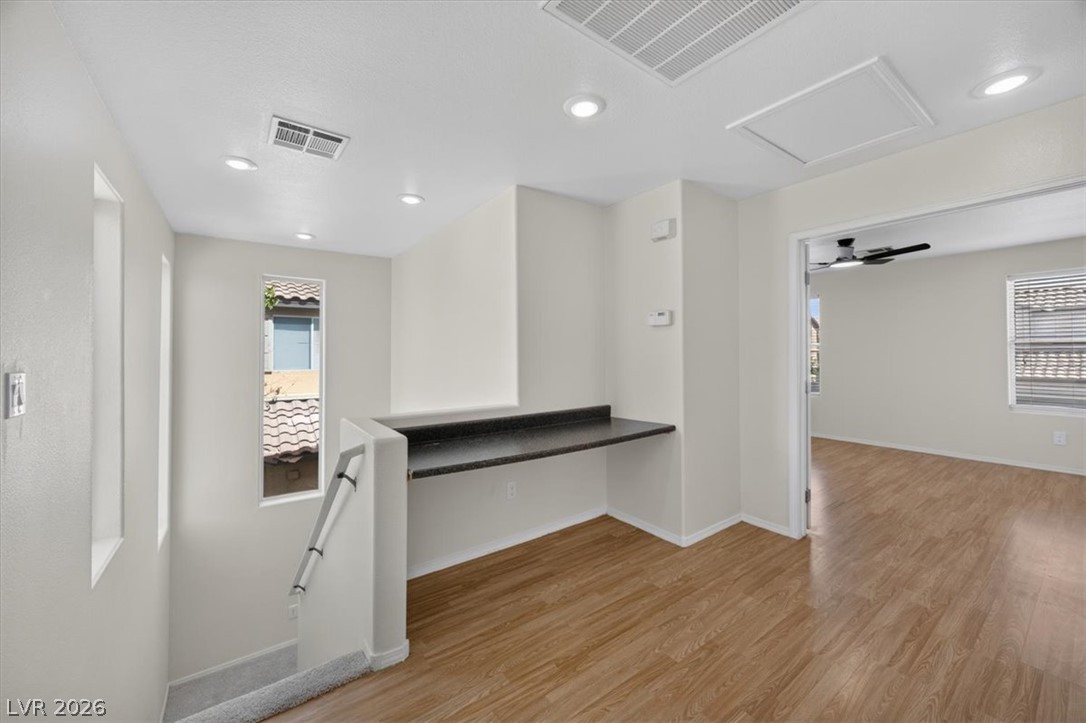 552 Albacate Street Henderson, NV 89015 - Photo 19 of 40 A versatile open landing with a built-in desk, ideal for a home office or study space.