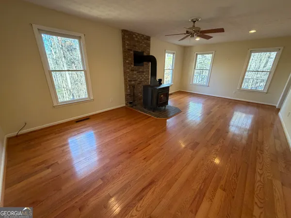 an empty room with windows and closet